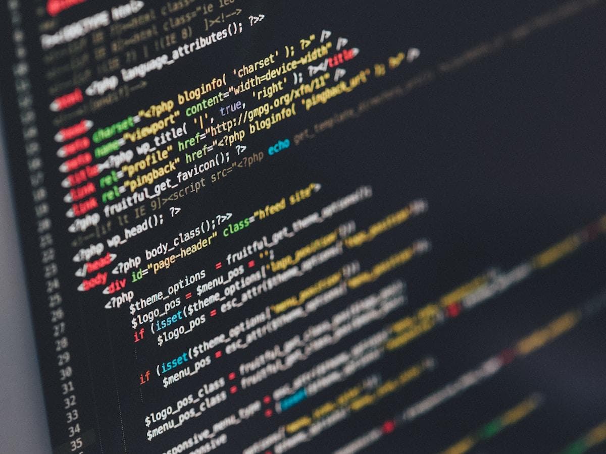 Developer writing code on multiple monitors in a software engineering environment